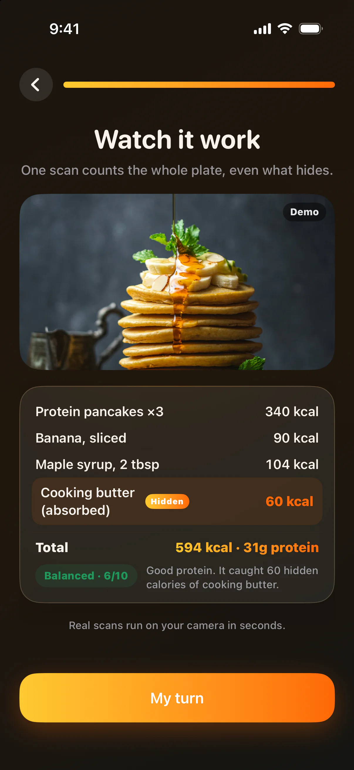 Brasa's demo scan of that plate: protein pancakes 340 kcal, banana 90, maple syrup 104, cooking butter (absorbed) 60 kcal marked Hidden. Total 594 kcal, 31 g protein. Balanced, 6 of 10.